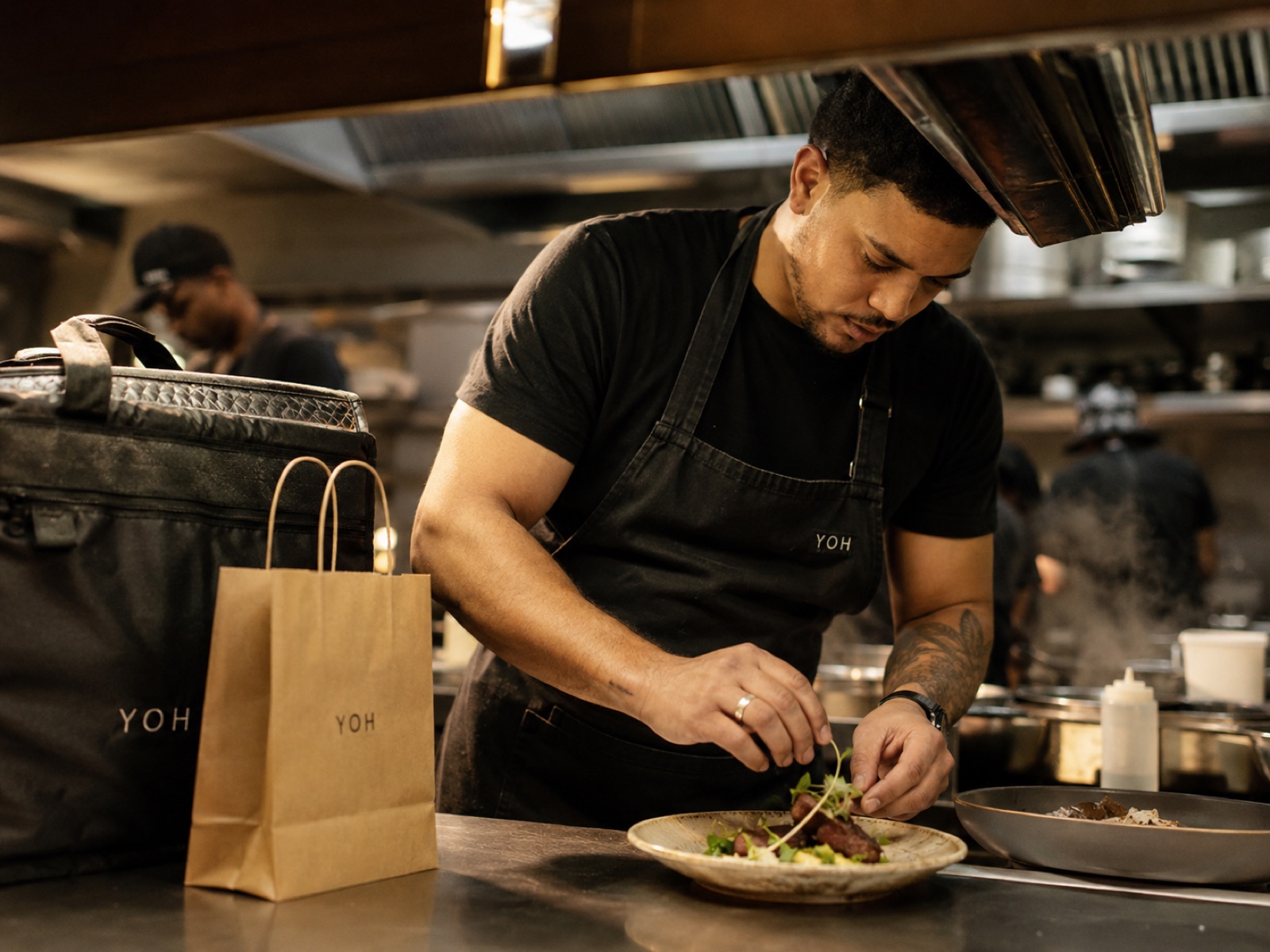 A chef plating a dish for a YOH order
