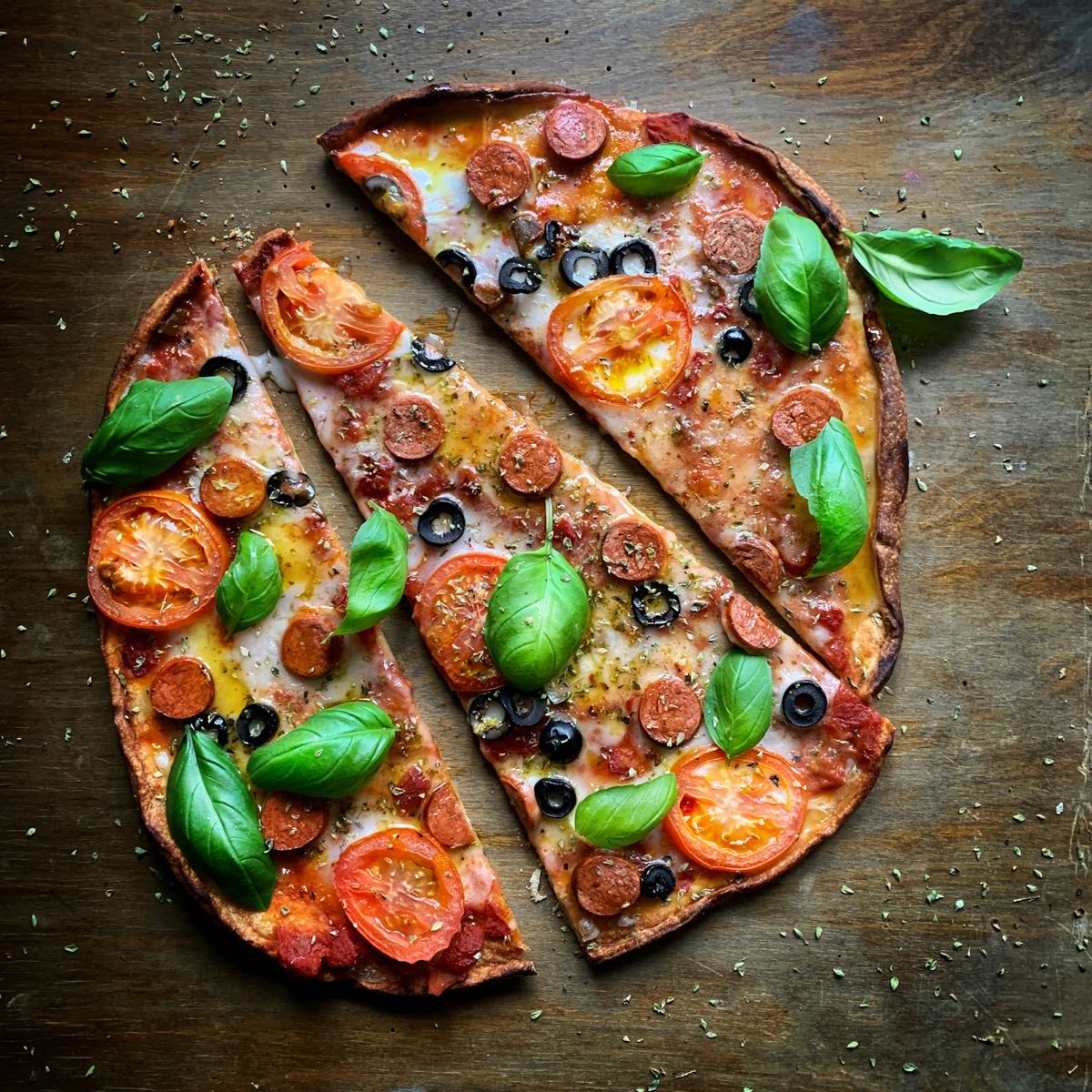 A fresh wood-fired pizza with tomato, basil and pepperoni